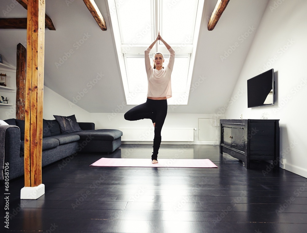 Female doing yoga at home