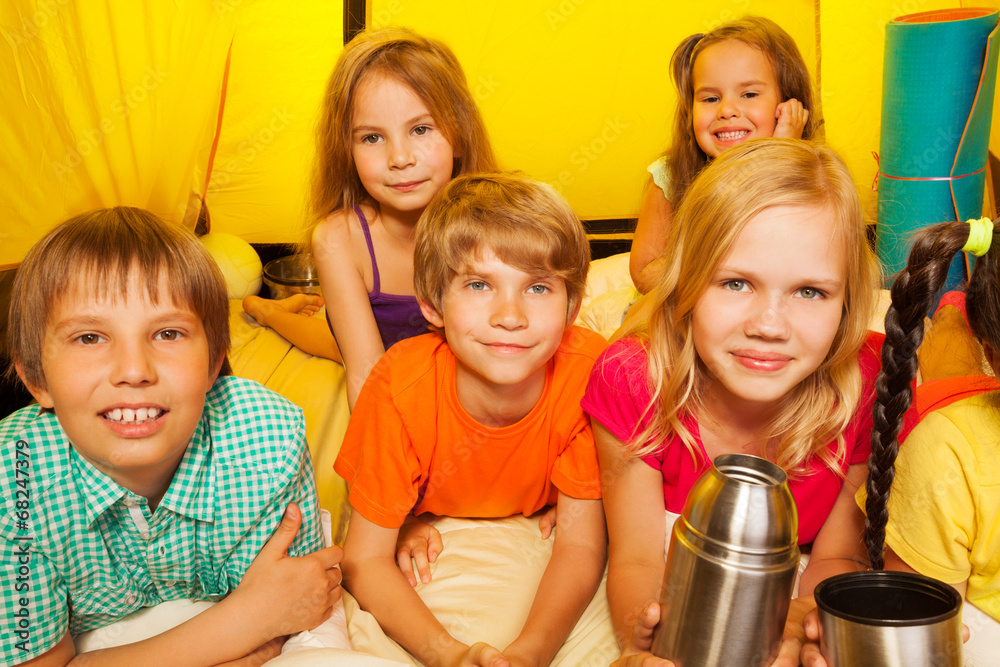 Group of kids lay in the tent