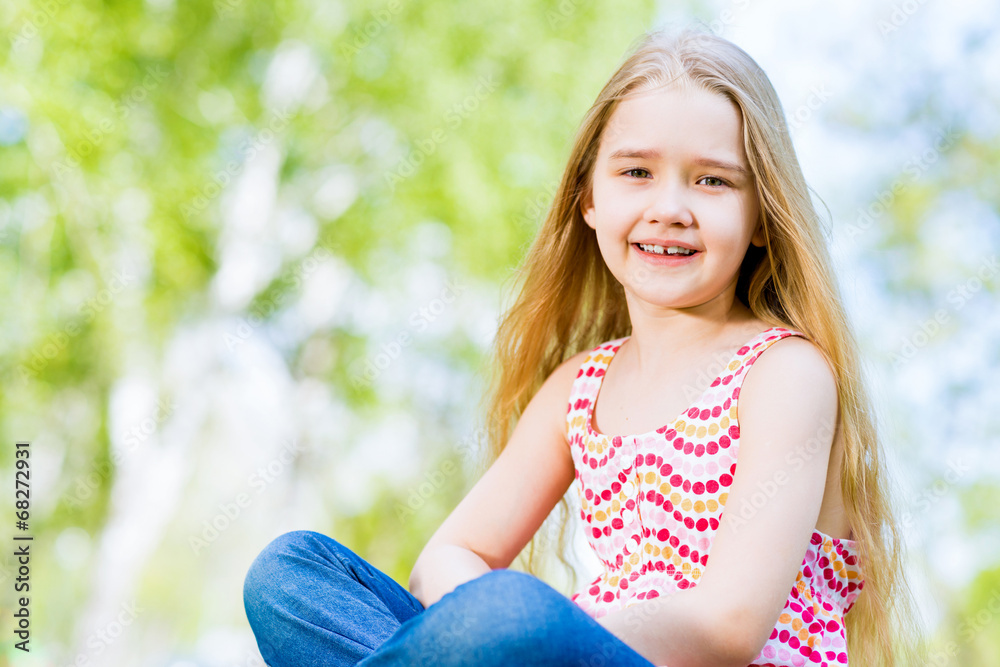 portrait of a smiling girl in a park