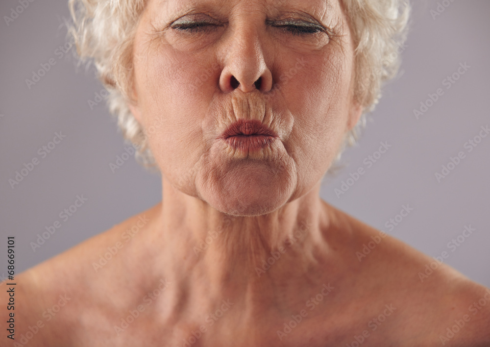 Senior woman puckering lips