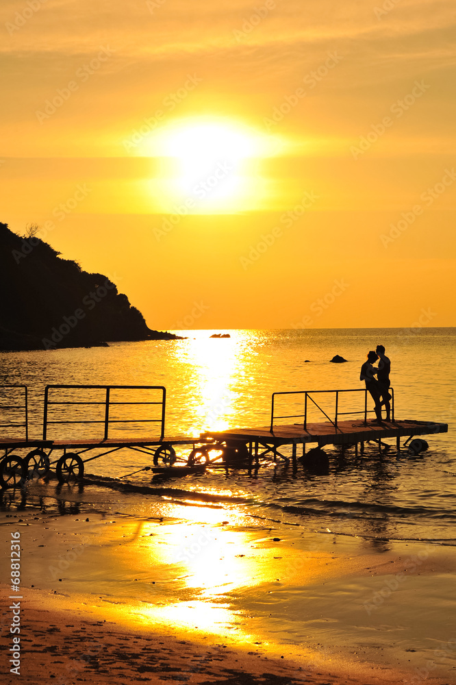 Silhouette scene of couple in sunset at beach