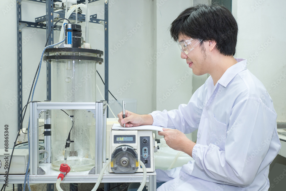 Scientist conducting research taking notes  in laboratory