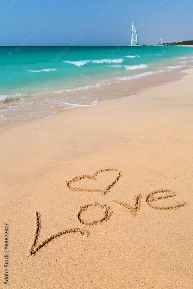 Love sign on the beach with turquoise water