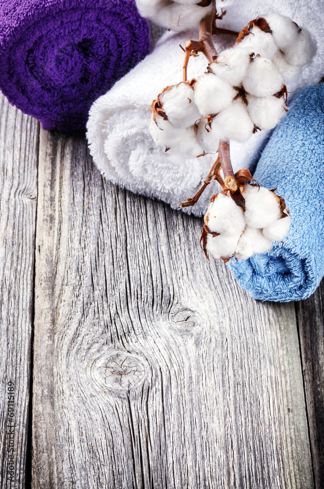 Branch of ripe cotton bolls on multicolor bath towels