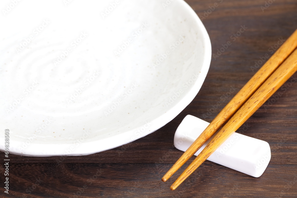 Close - up brown wooden chopsticks on table wood background