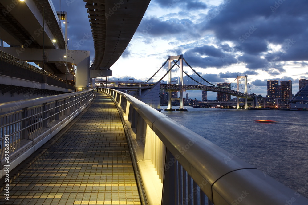 Tokyo bay and rainbow bridge at sunset time from  walking across