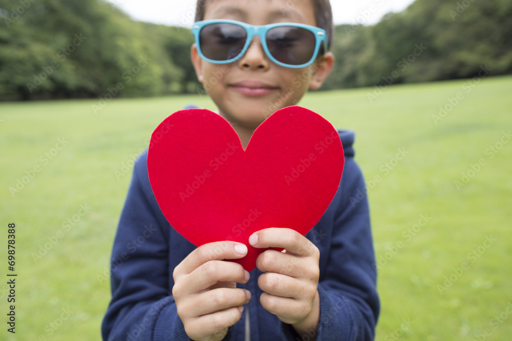 Children holding a red heart