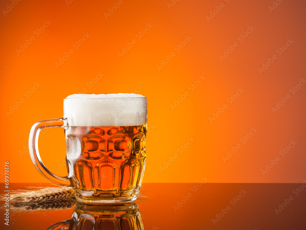 Glass of beer with orange background