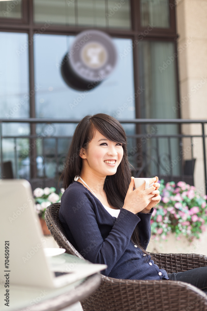 Young asian woman drinking coffee