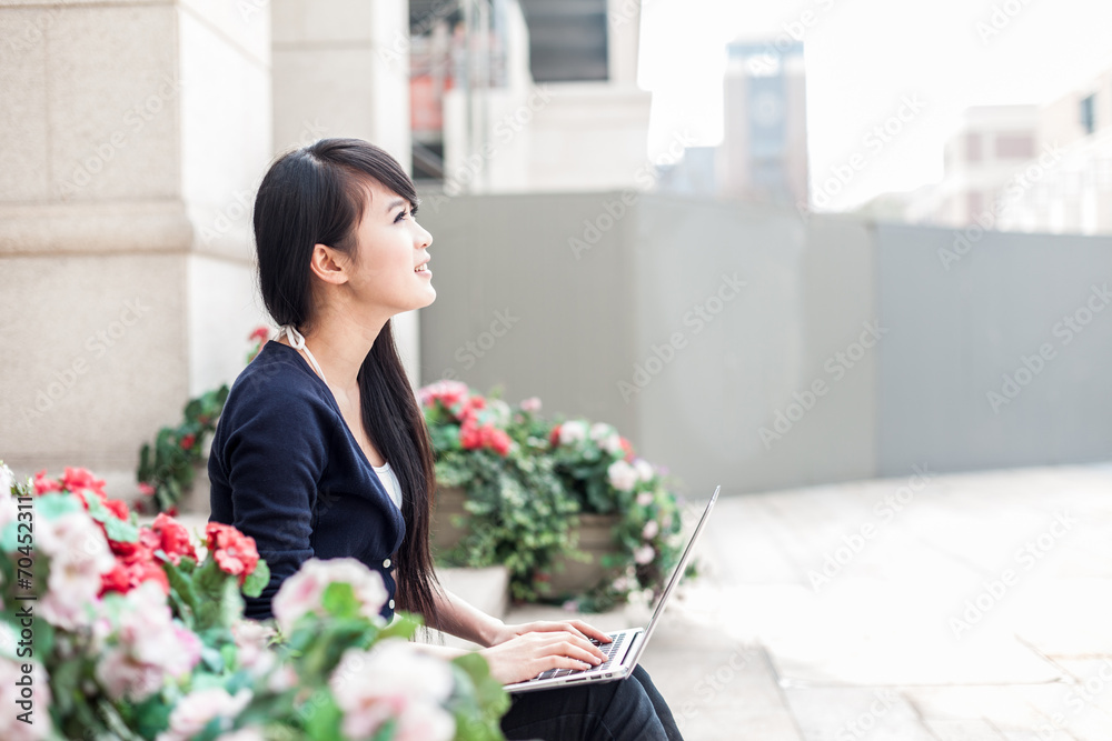 带笔记本电脑的亚洲年轻女性