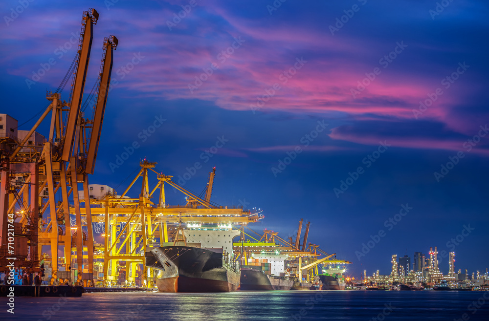 Container Cargo freight ship with working crane bridge in shipya