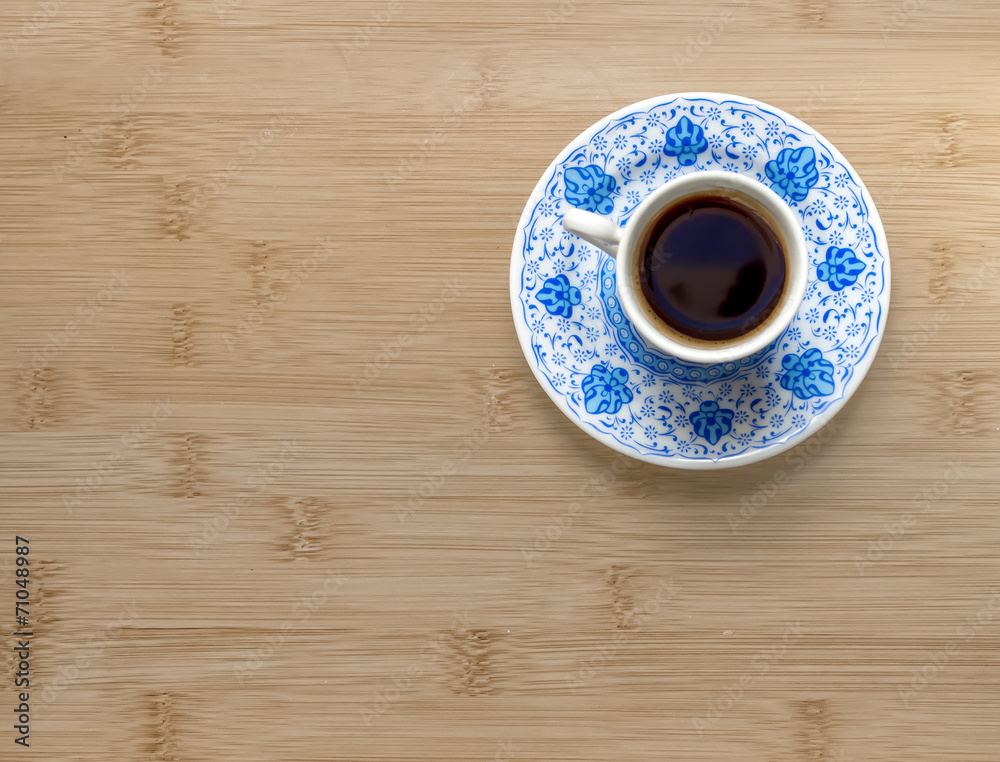 A cup of Turkish coffee on a wooden background