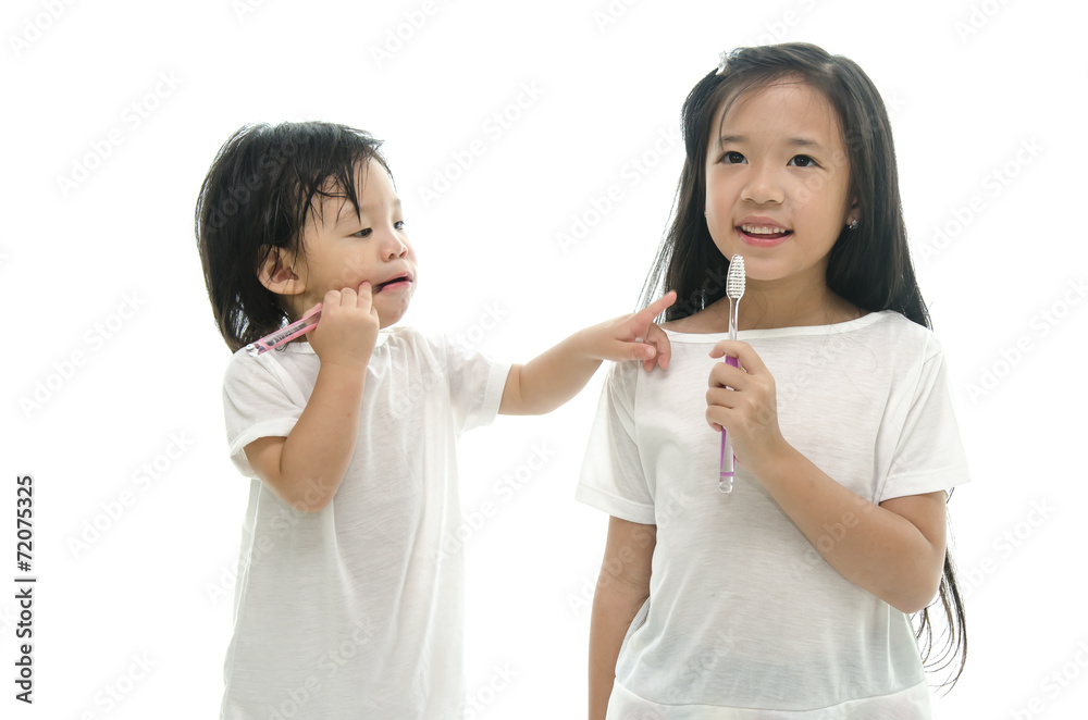 Little  asian girl and boy brushing teeth