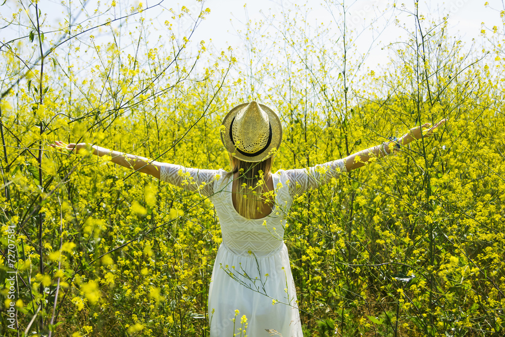 Girl among yellow flowers