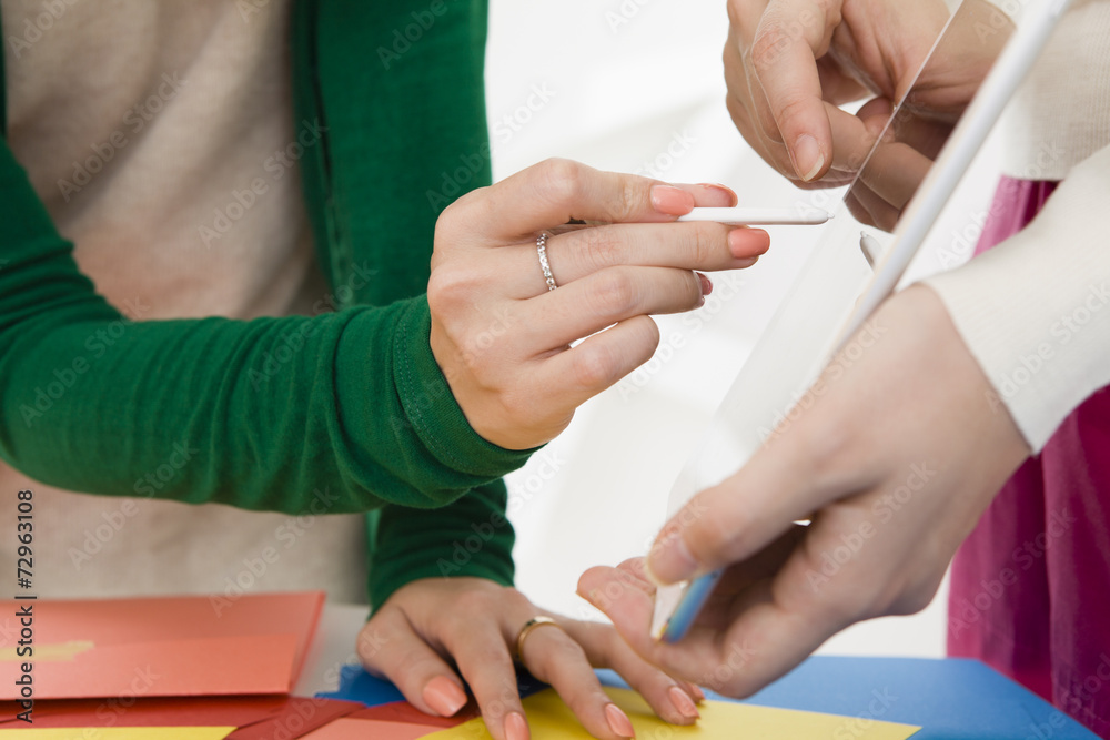 Woman pointing to the tablet with the touch pen