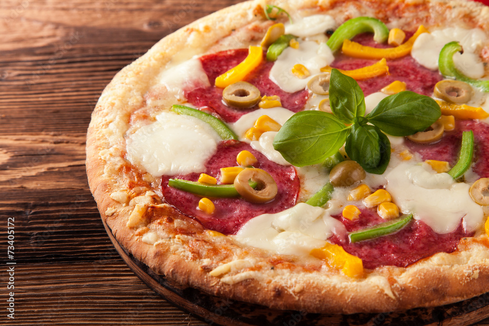 Delicious fresh pizza served on wooden table