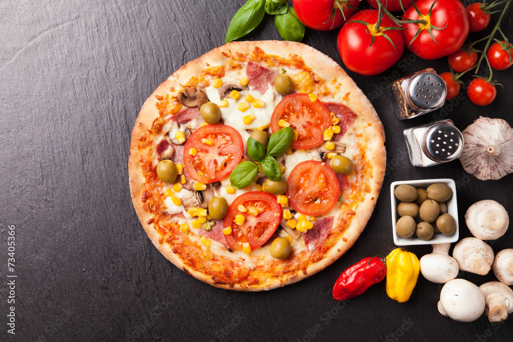 Delicious fresh pizza served on black stone