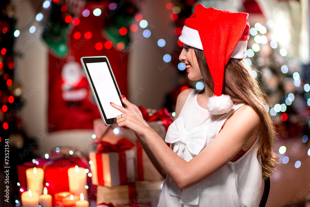 Young woman using tablet on Christmas