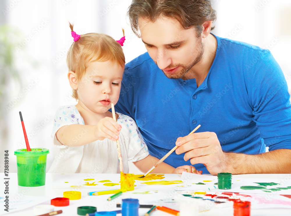 happy family father and child  daughter together draw paints