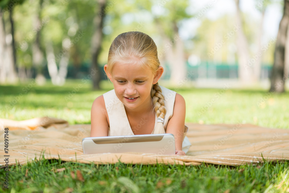 Kid in park lying on blanket