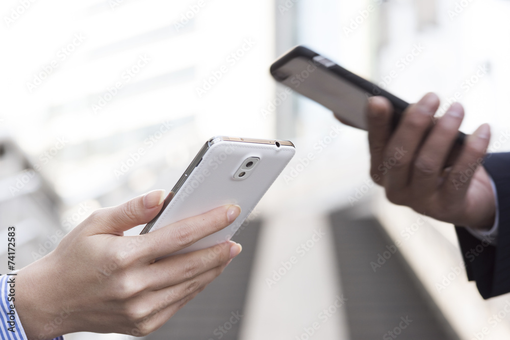 Two businessmen have a cell phone