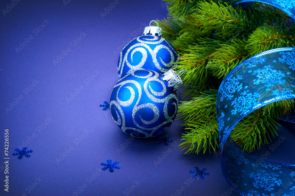 Christmas blue baubles with ribbon over blue background