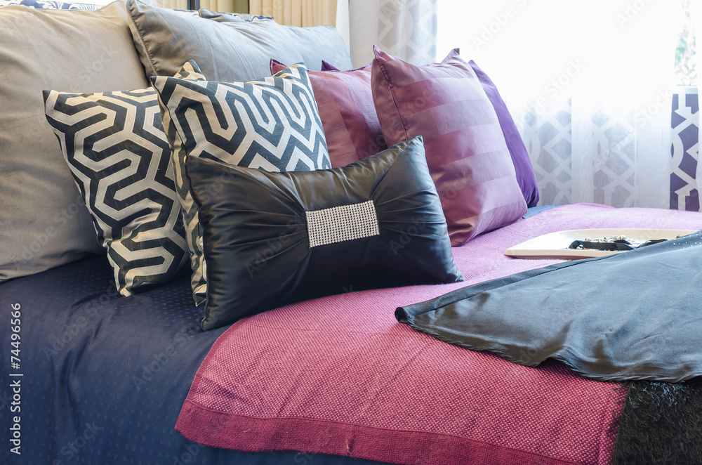 multicolor pillows on bed in bedroom