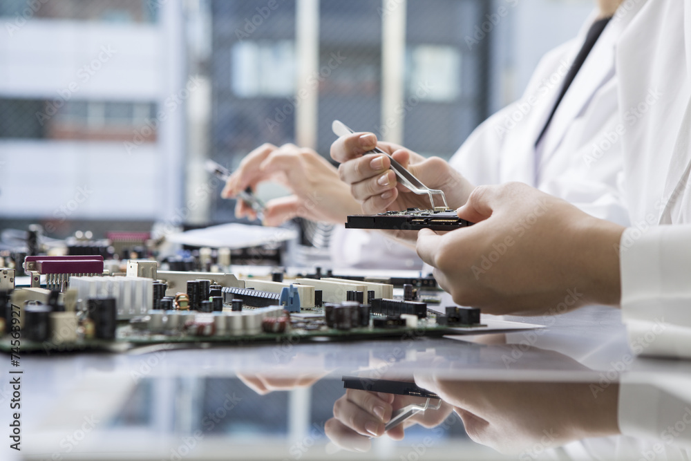 Women who have been repairing the computer parts