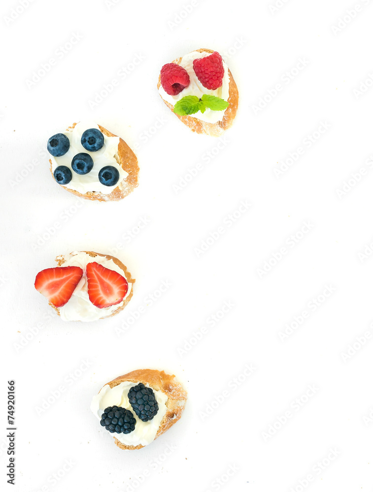 Selection of small sweet sandwiches with cream-cheese and fresh