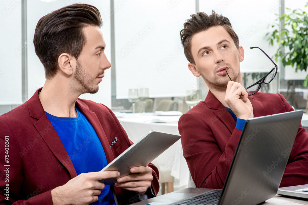 Two brothers twins working at the office