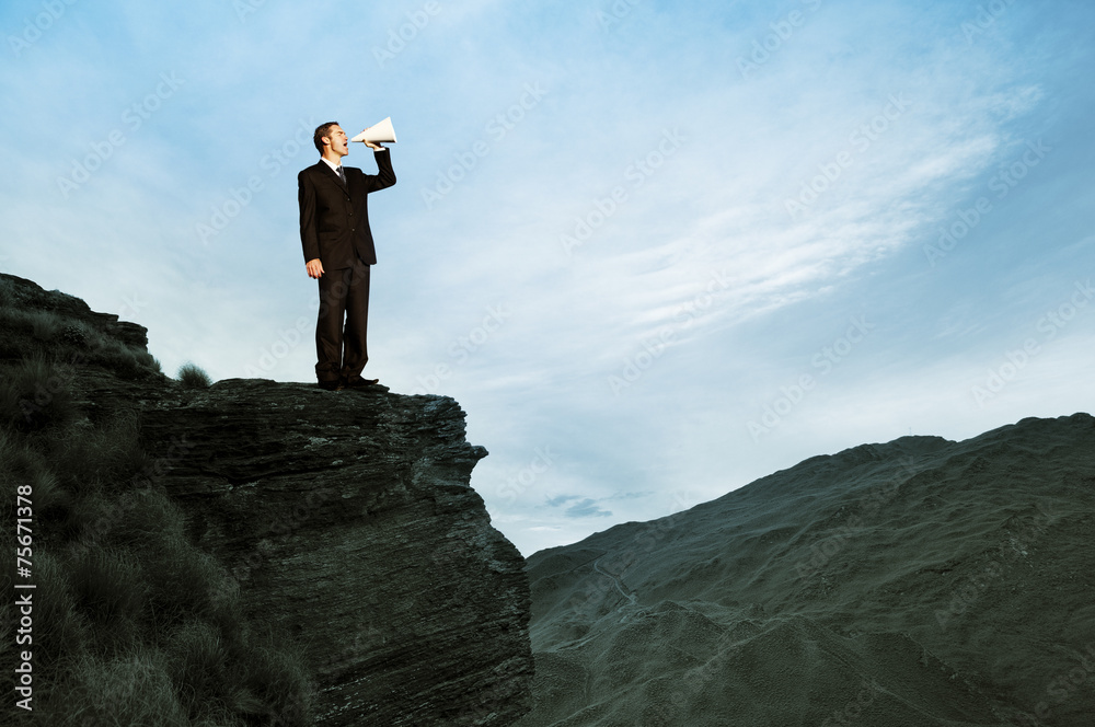 Businessman Shouting on the Top of the Mountain