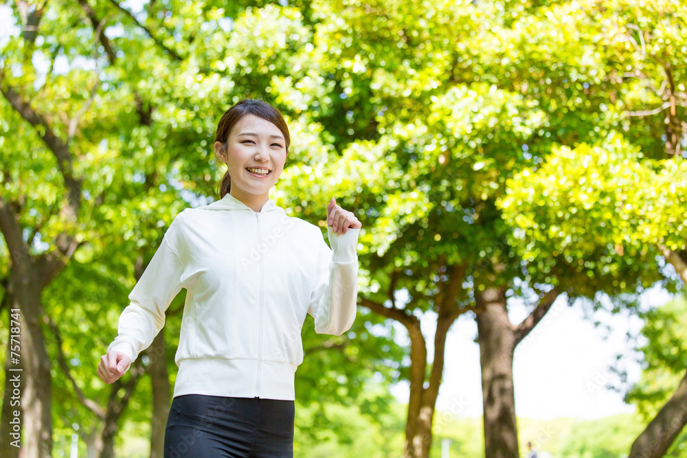 在公园里奔跑的亚洲年轻女子