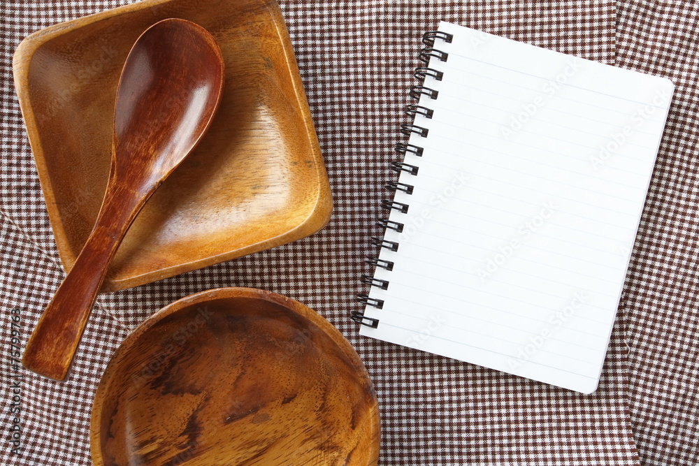 Blank open notebook and kitchen utensils for recipes