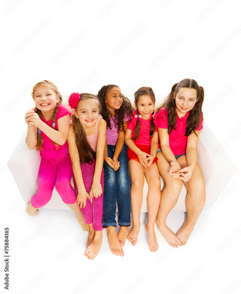 View from top of small girls sitting on white sofa