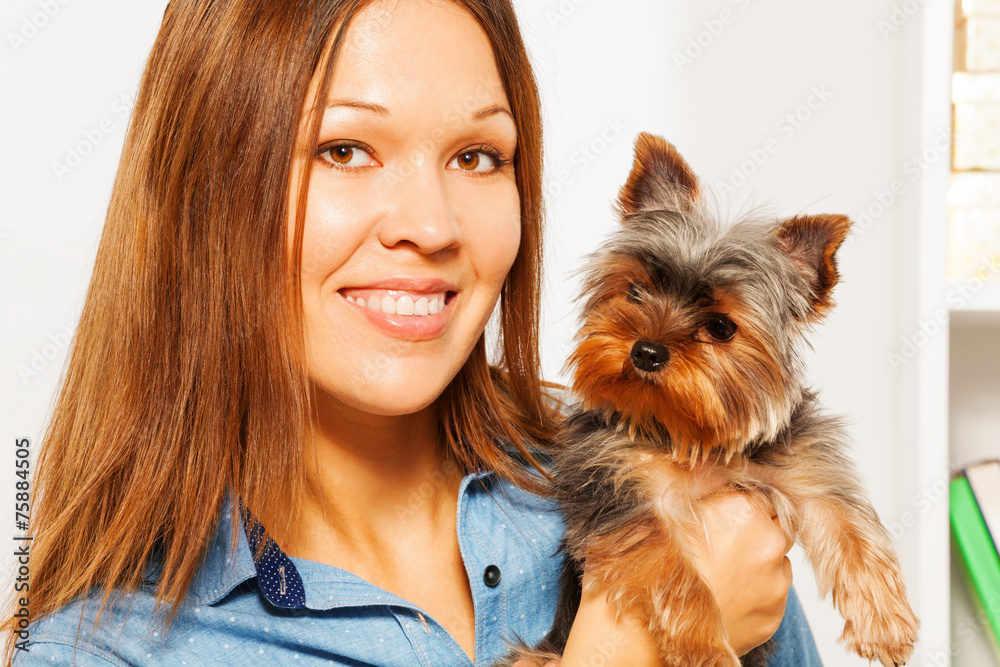 Portrait of brown Yorkshire Terrier and woman