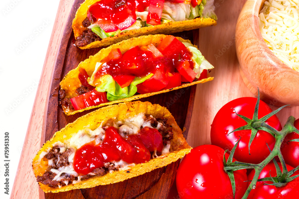 Mexican tacos in tortilla shells with fresh vegetables