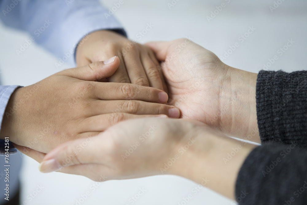 Hand of overlapping mother and son