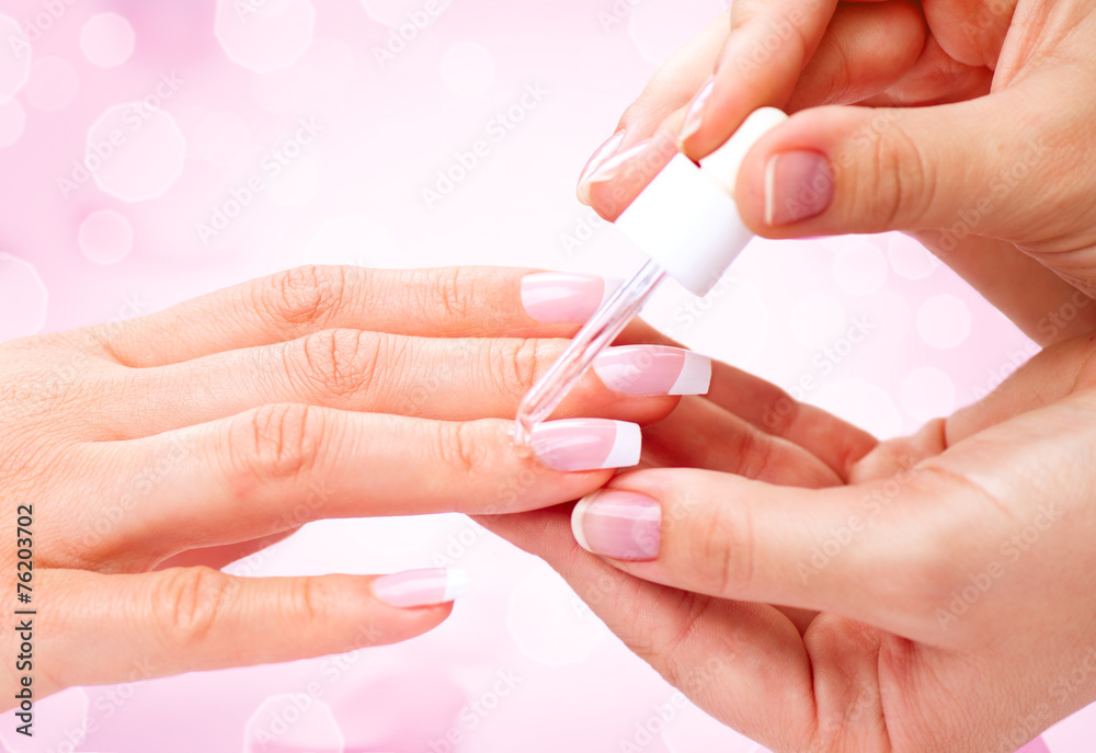 Manicure, hands spa cuticle oil. Beautiful woman hands closeup