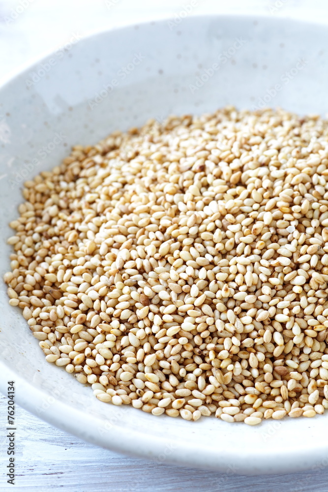 Organic natural sesame seeds on white wood table