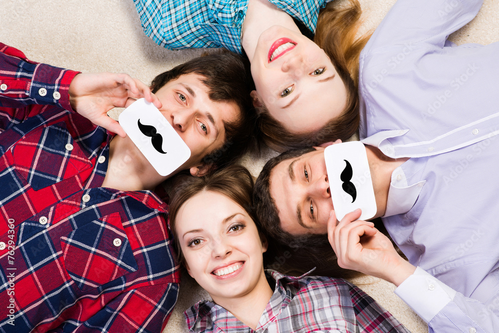 four young men lie together