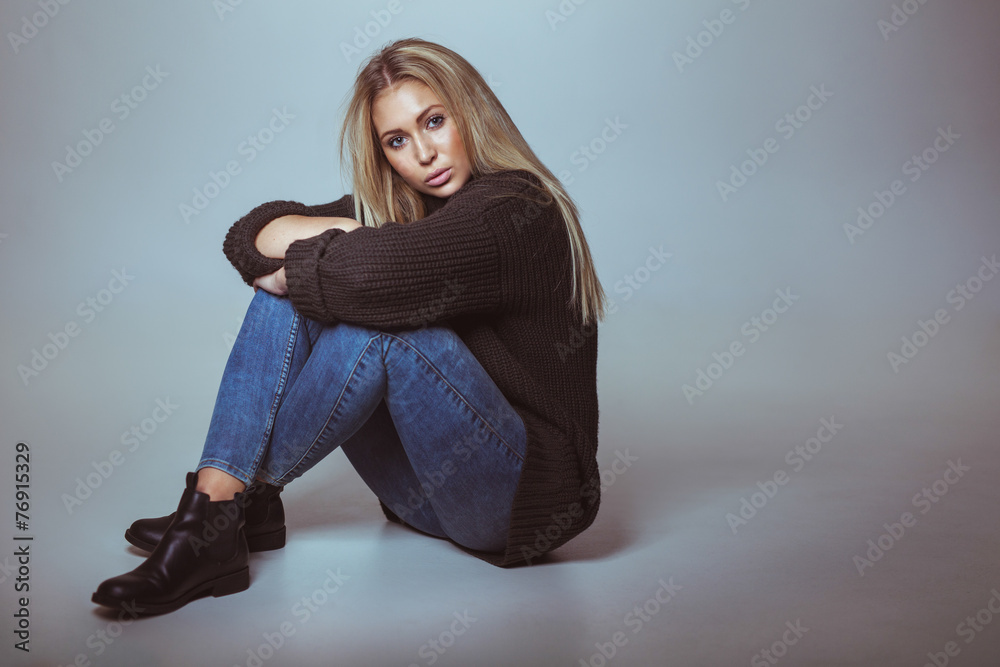 Attractive woman sitting on floor