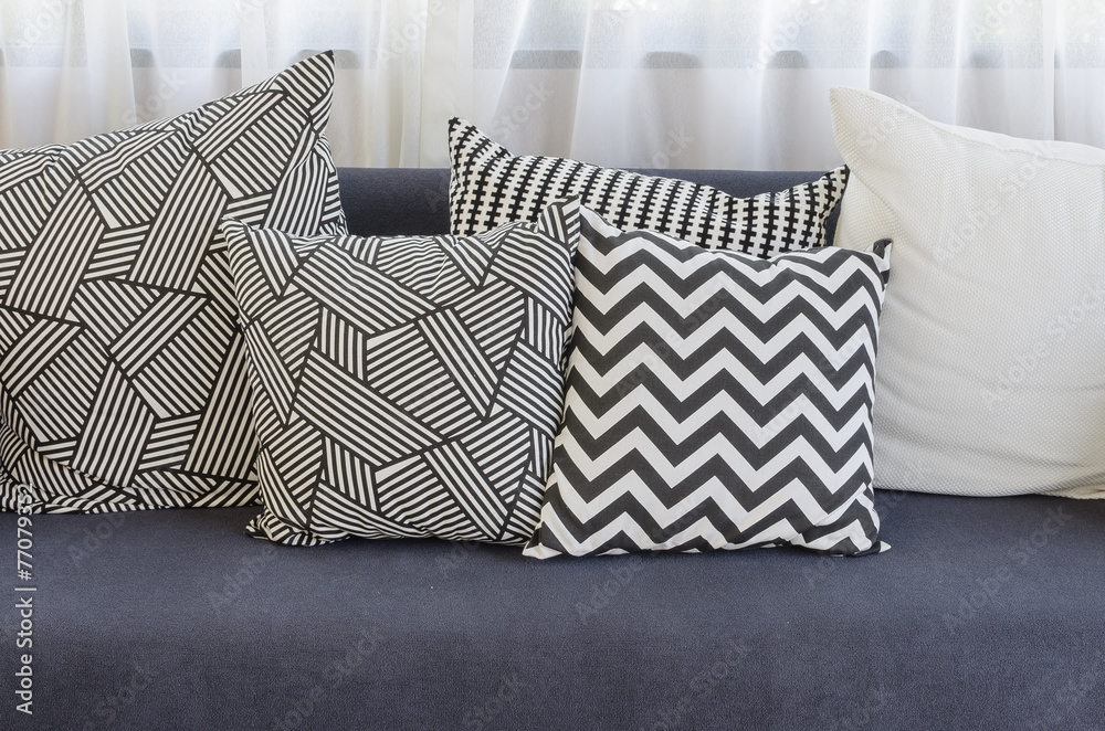 black and white pillows on blue sofa in living room