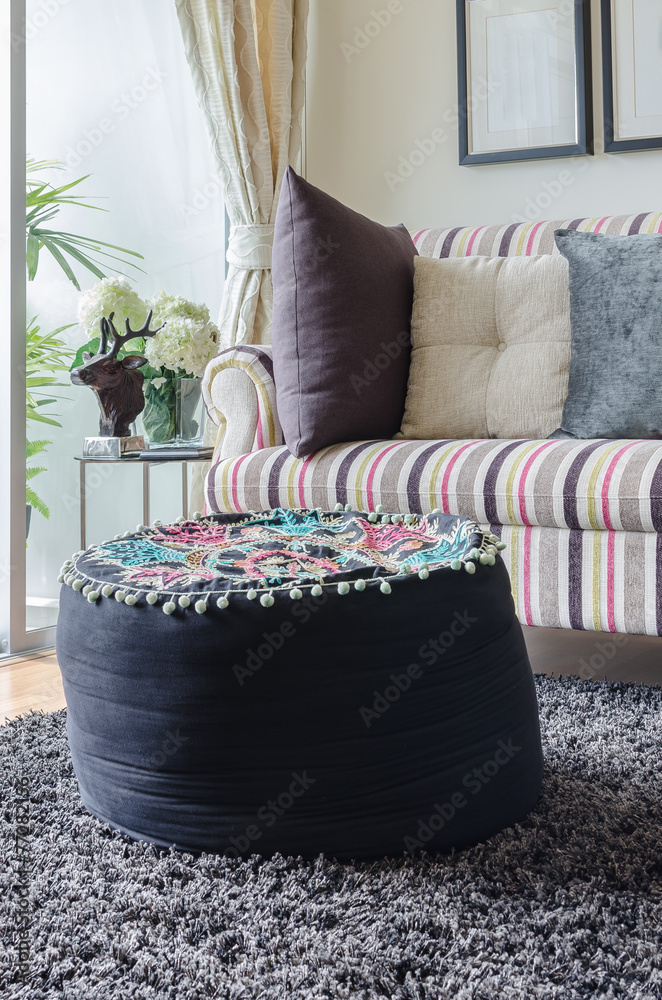 black round cushion on carpet in living room