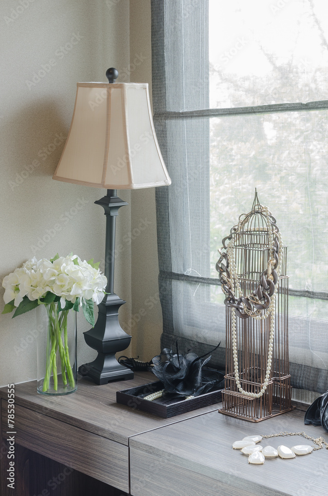 lamp with vase of plant on dressing table