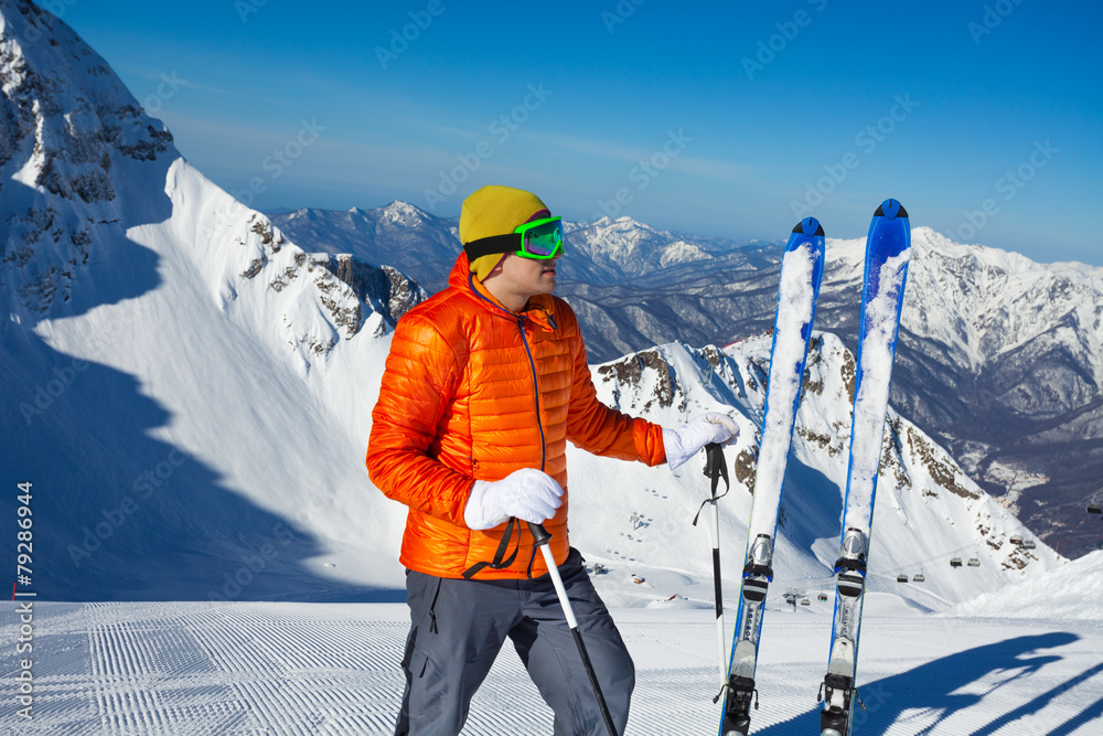 男子与滑雪板站在雪地和后面的山上