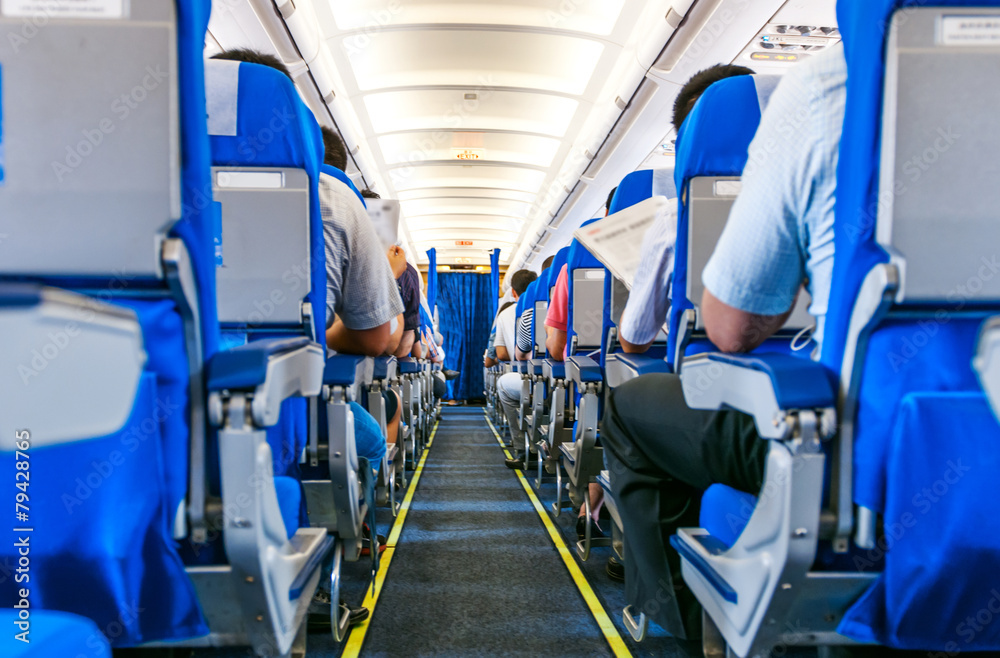 Interior of airplane with passengers on seats