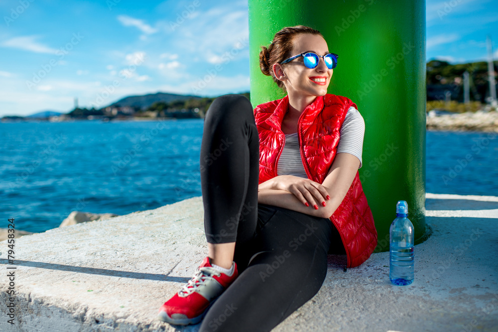 Sport woman resting near the sea