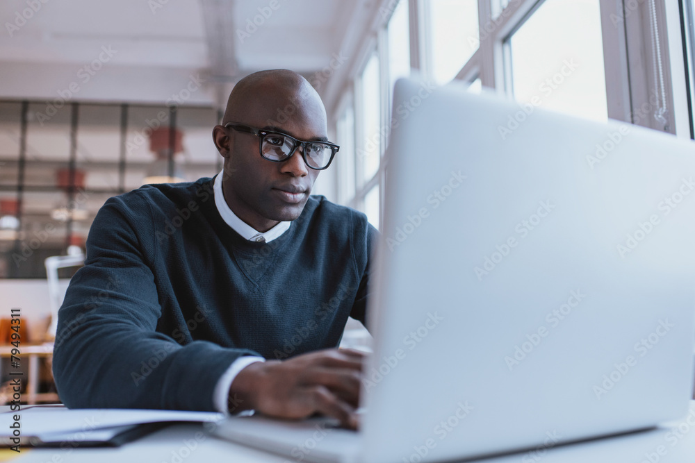 Young businessman working on his laptop