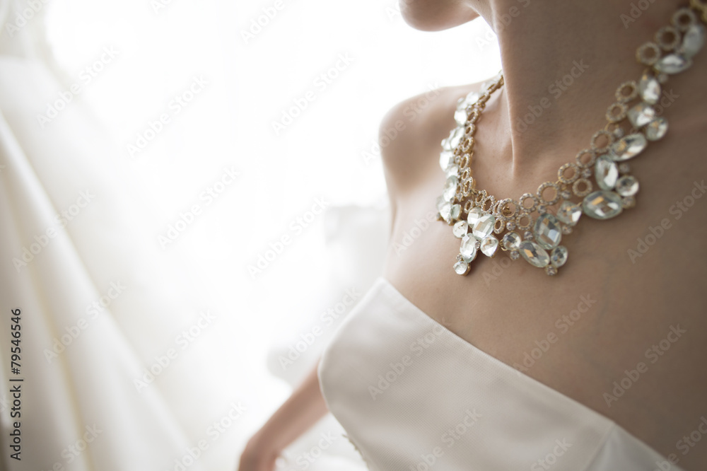 The bride wears a gorgeous necklace