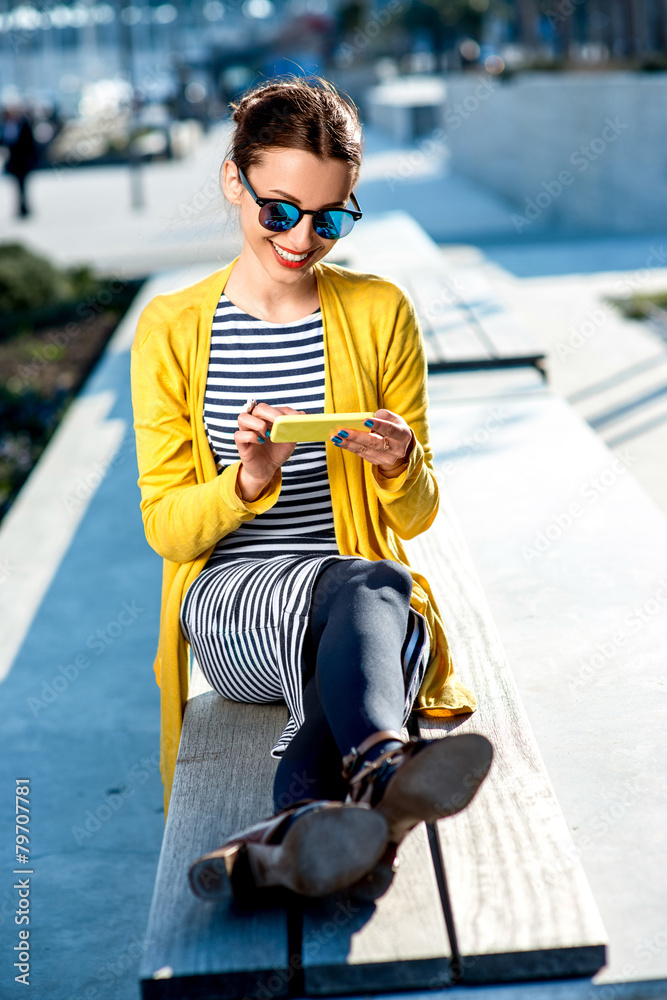 Woman with phone outdoors